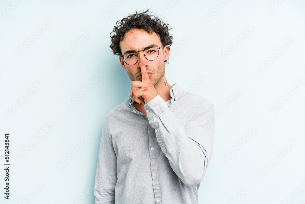 Young caucasian man isolated on blue background keeping a secret or asking for silence. Young caucasian man isolated on blue background keeping a secret or asking for silence.