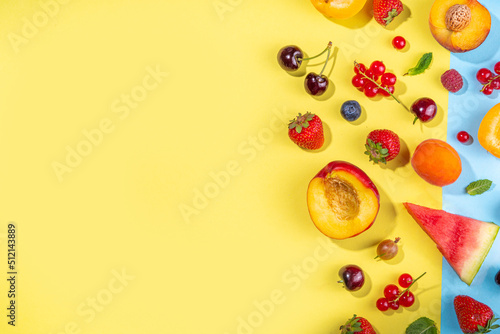 Summer vitamin food concept, various fruit and berries watermelon peach mint plum apricots blueberry strawberry currant, creative flat lay on yellow background top view copy space