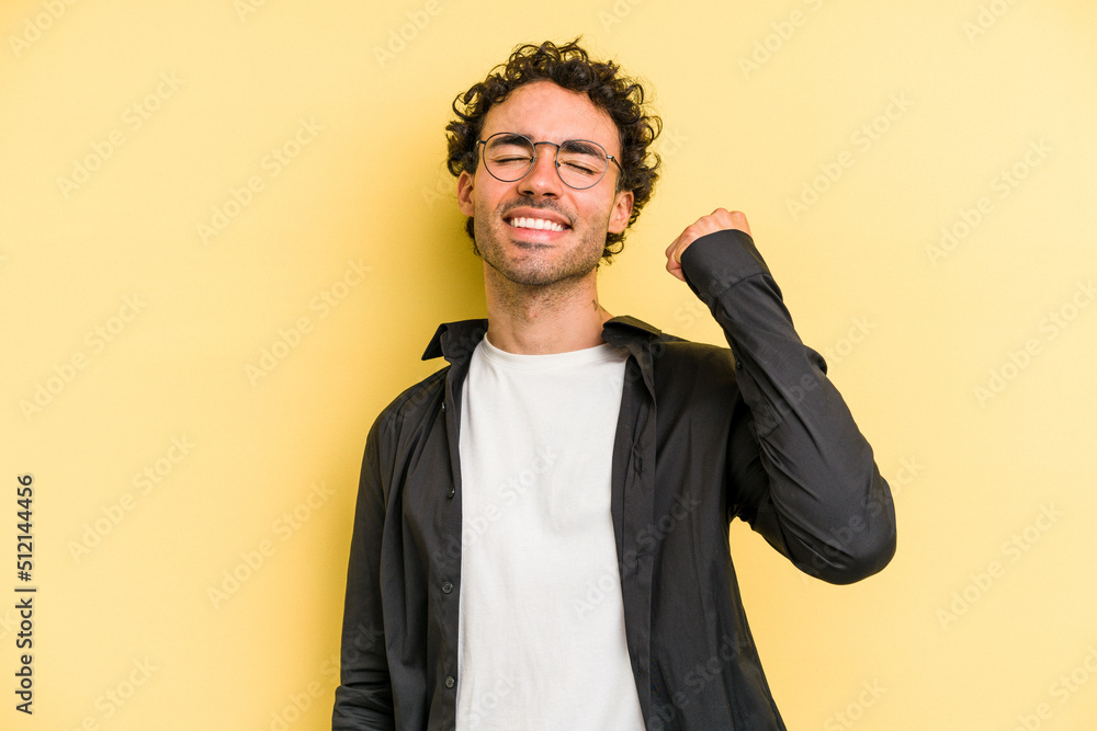 Fototapeta premium Young caucasian man isolated on yellow background celebrating a victory, passion and enthusiasm, happy expression.