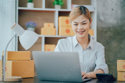 Looking camera, Startup small business SME, Entrepreneur owner using tablet taking receive and checking online purchase shopping order to preparing pack product box