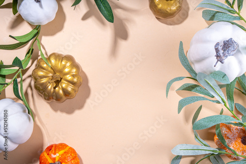 Fall seasonal flatlay. Autumn seasonal holidays background in pink colors. White, orange, golden pumkins decor for thanksgiving, fall holidays, invitation mock up background