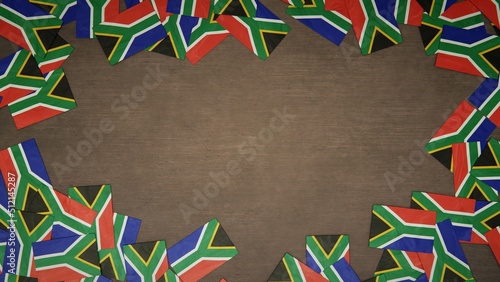 Frame made of paper flags of South Africa arranged on wooden table. National celebration concept. 3D illustration