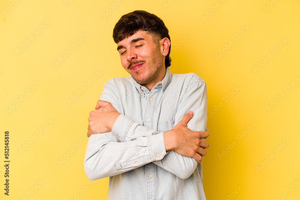 Young caucasian man isolated on yellow background hugs, smiling carefree and happy. Young caucasian man isolated on yellow background hugs, smiling carefree and happy.