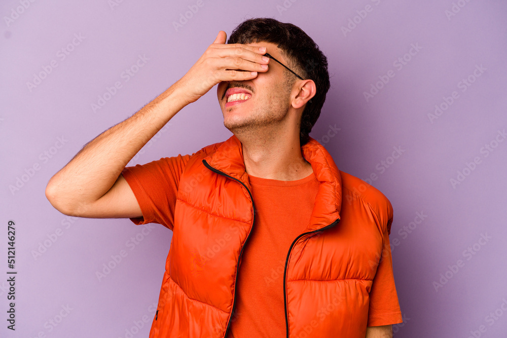 Young caucasian man isolated on purple background laughs joyfully keeping hands on head. Happiness concept. Young caucasian man isolated on purple background laughs joyfully keeping hands on head. Happiness concept.