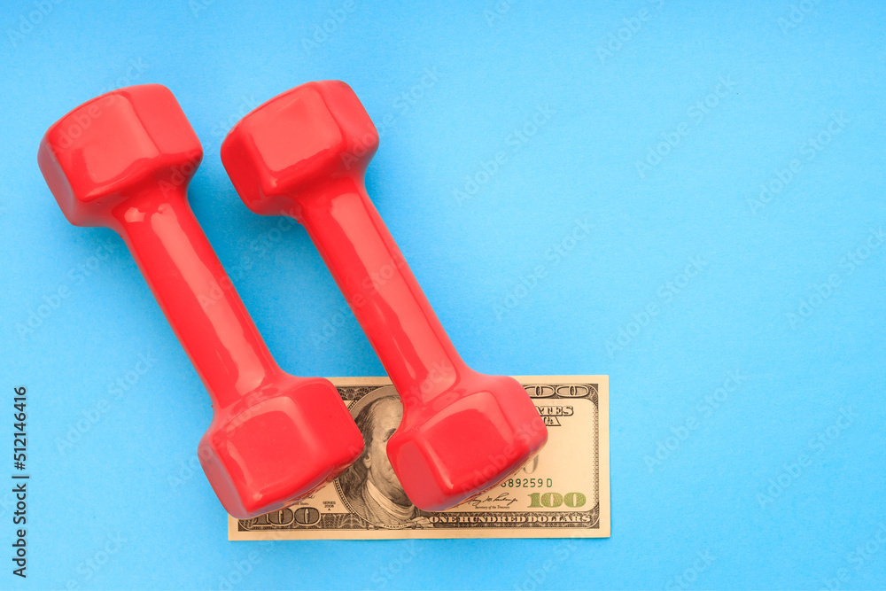 two red dumbbells on a blue background, under the dollar dumbbells two red dumbbells on a blue background, under the dollar dumbbells