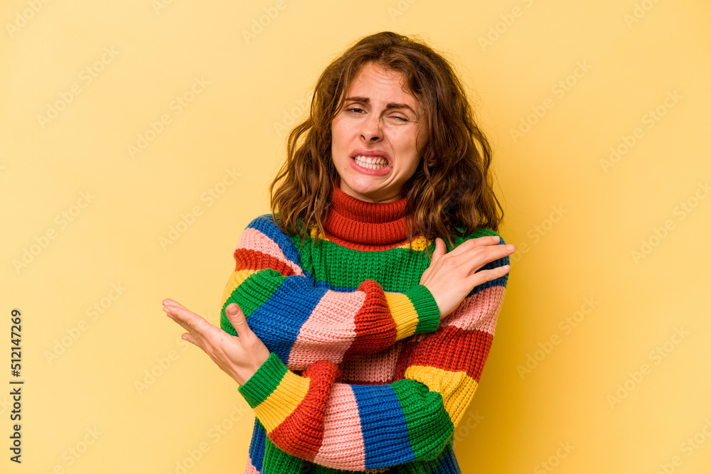 Young caucasian woman isolated on yellow background massaging elbow, suffering after a bad movement. Young caucasian woman isolated on yellow background massaging elbow, suffering after a bad movement.