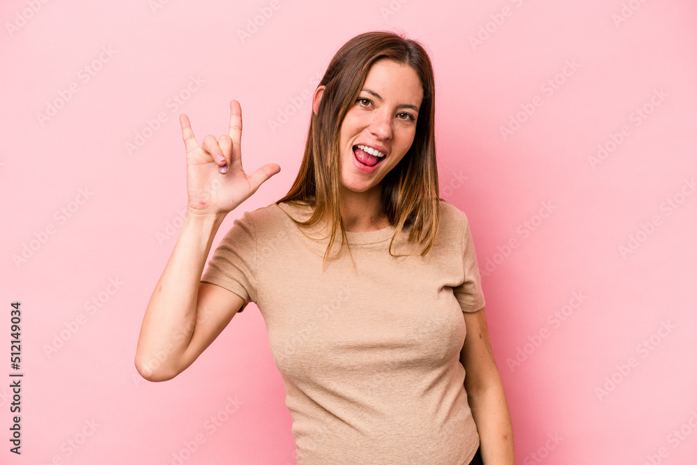 Young caucasian pregnant woman isolated on white background showing a horns gesture as a revolution concept. Young caucasian pregnant woman isolated on white background showing a horns gesture as a revolution concept.