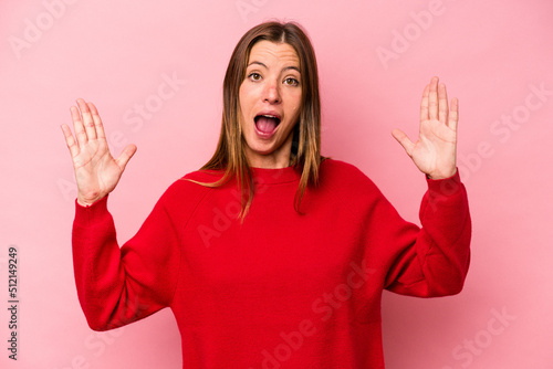 Young caucasian pregnant woman isolated on white background receiving a pleasant surprise, excited and raising hands.