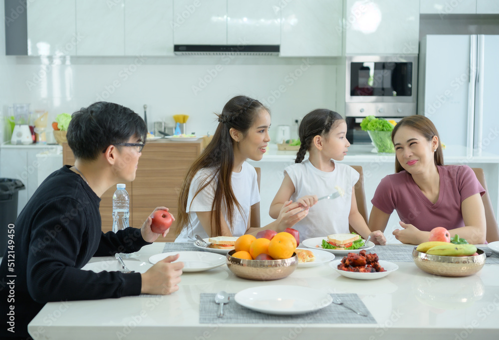 Asian family They are having breakfast together happily in the dining room of the house. Asian family They are having breakfast together happily in the dining room of the house.