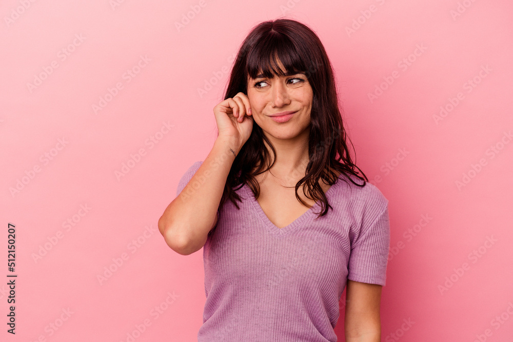 Young caucasian woman isolated on pink background covering ears with fingers, stressed and desperate by a loudly ambient. Young caucasian woman isolated on pink background covering ears with fingers, stressed and desperate by a loudly ambient.