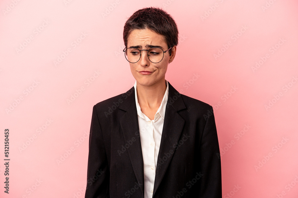 Young business woman isolated on pink background confused, feels doubtful and unsure. Young business woman isolated on pink background confused, feels doubtful and unsure.