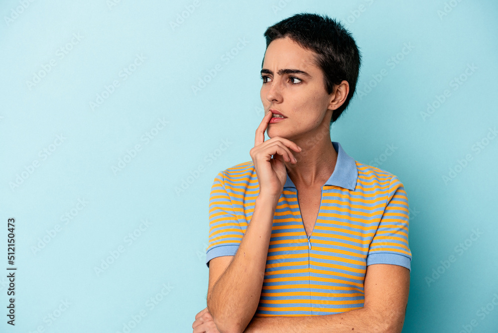 Young caucasian woman isolated on blue background looking sideways with doubtful and skeptical expression. Young caucasian woman isolated on blue background looking sideways with doubtful and skeptical expression.