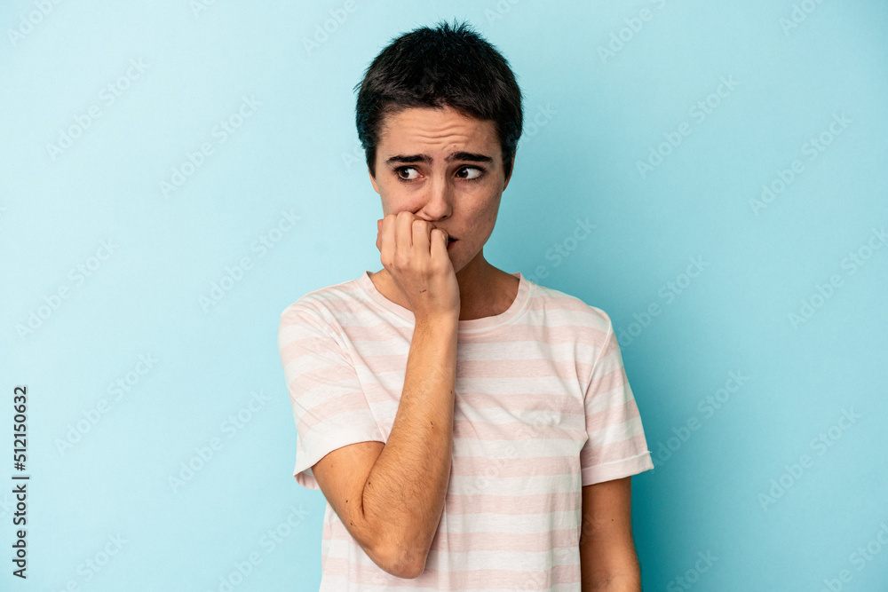 Young caucasian woman isolated on blue background biting fingernails, nervous and very anxious. Young caucasian woman isolated on blue background biting fingernails, nervous and very anxious.