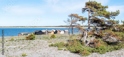 Fishermans cabin in a row by the sea. Huts on the island of Gotland in Sweden.