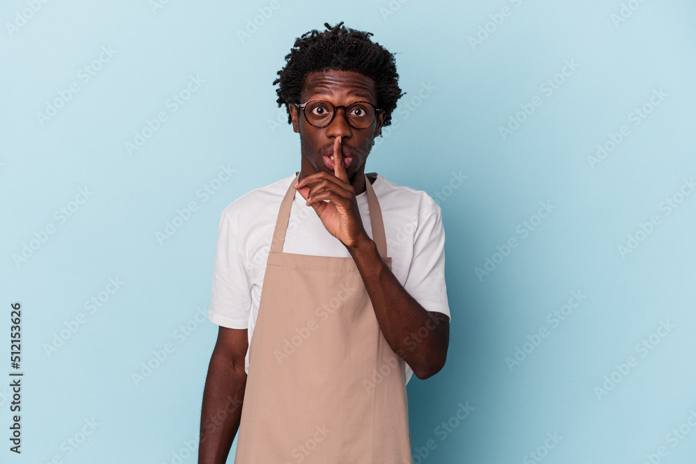 Young african american store clerk isolated on blue background keeping a secret or asking for silence. Young african american store clerk isolated on blue background keeping a secret or asking for silence.
