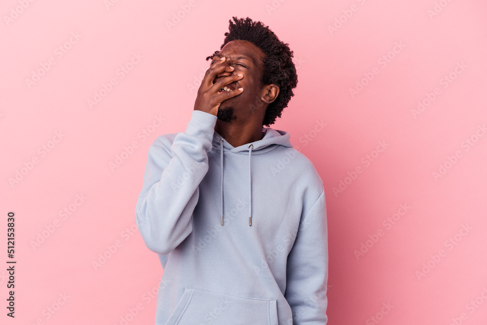 Young african american man isolated on pink background laughing happy, carefree, natural emotion. Young african american man isolated on pink background laughing happy, carefree, natural emotion.