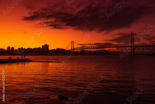 Hercilio luz cable bridge with sunset sky and reflection on water in Florianopolis © artifirsov