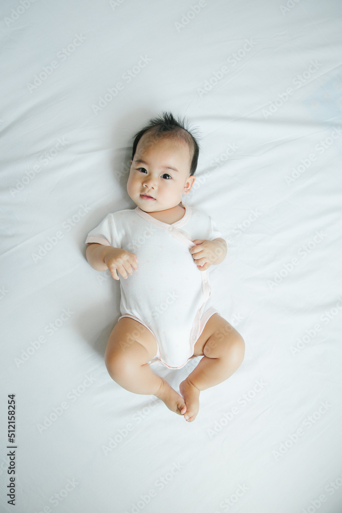 Asian baby lying on bed with soft blanket indoors cute little asian newborn baby Asian baby lying on bed with soft blanket indoors cute little asian newborn baby
