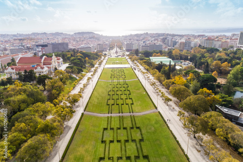 Aerial view of observation deck of Parque Eduardo VII or Park of Eduard the VII Sloped, scenic park featuring tree-lined walking paths, manicured lawns & distant water views in Lisbon  photo