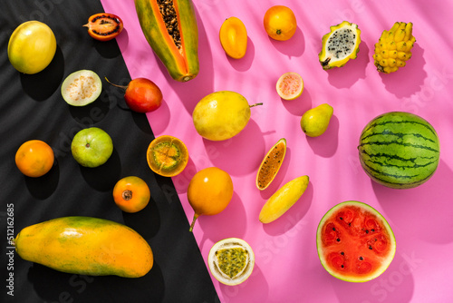 Canvastavla Variety of tropical fruits on fuchsia and black background