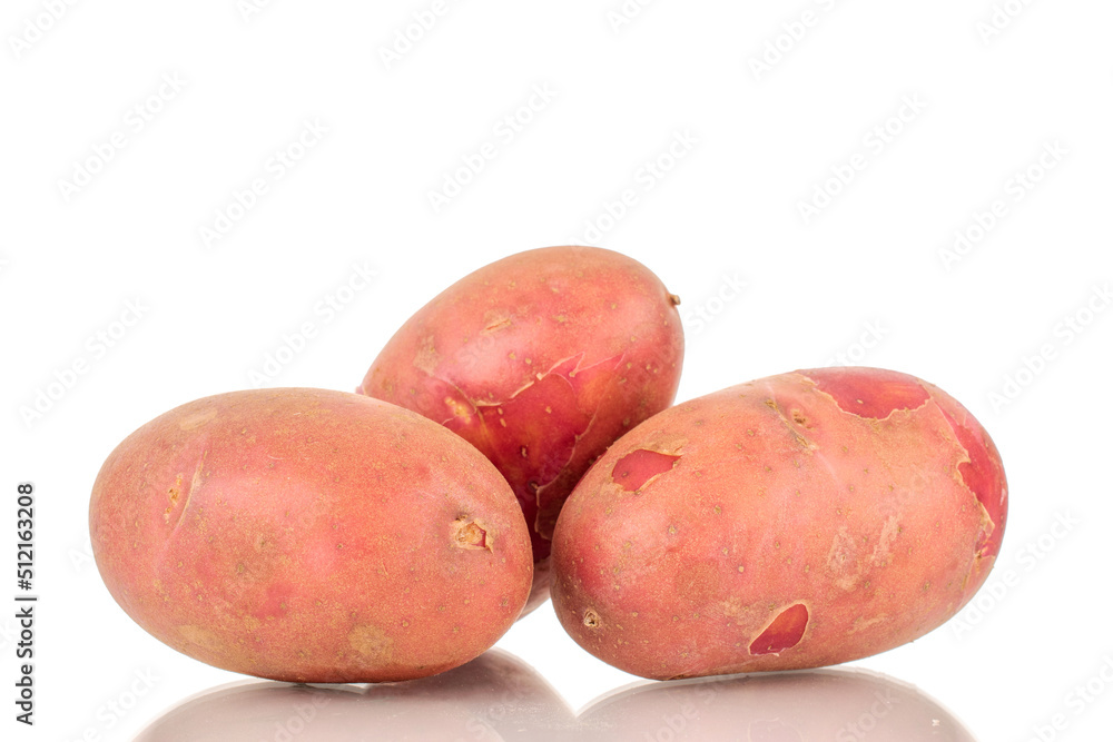 Several organic pink potatoes, close-up, isolated on a white background. Several organic pink potatoes, close-up, isolated on a white background.