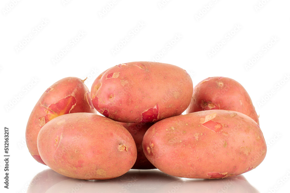 Several organic pink potatoes, close-up, isolated on a white background. Several organic pink potatoes, close-up, isolated on a white background.