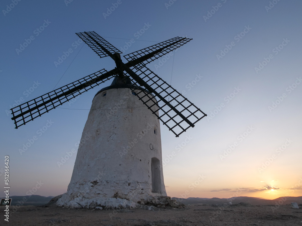 Sunrise with a windmill in a hill in Consuegra. La Mancha. Don Quixote. Spain