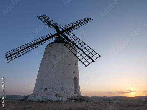 Sunrise with a windmill in a hill in Consuegra. La Mancha. Don Quixote. Spain