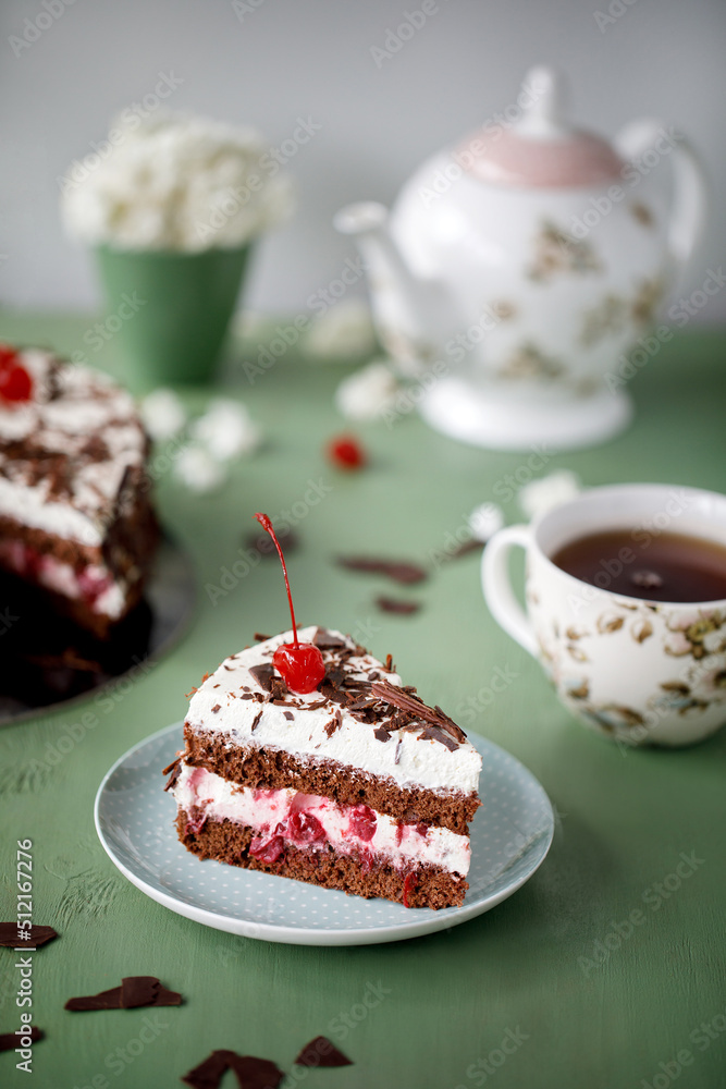 Cherry cake and chocolate on the background with flowers Cherry cake and chocolate on the background with flowers