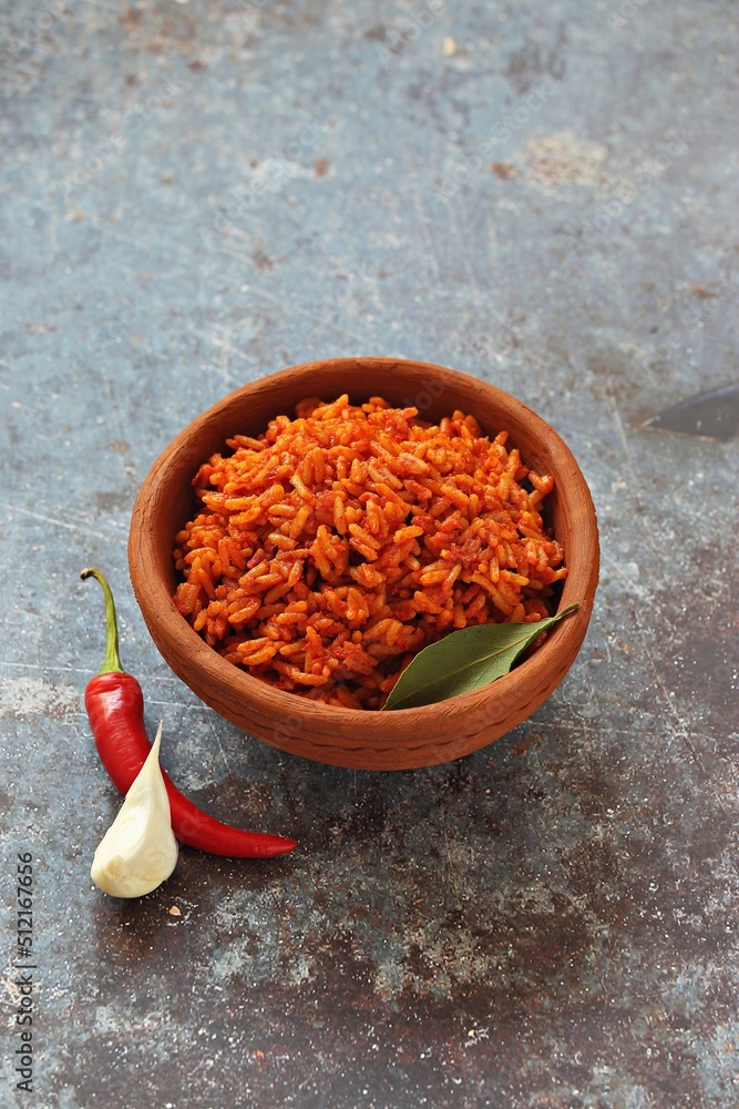 Jollof Rice. Traditional Nigerian spicy rice dish. National Jollof Rice day. Stock Photo Adobe