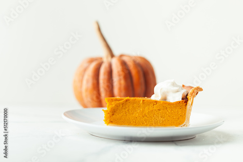 Obraz na płótnie Cut slice of pumpkin pie close up on white background