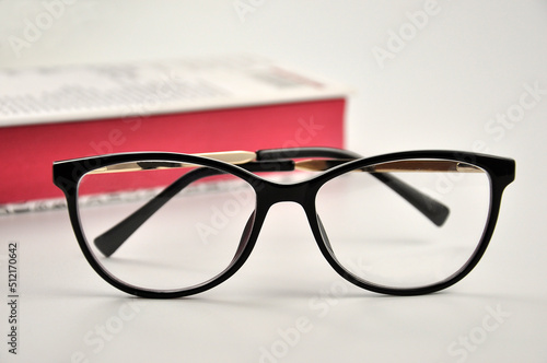 Glasses and book on white background.