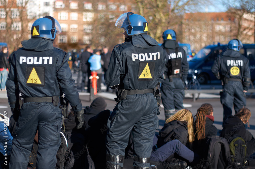 Ready for anything. Rearview shot of a police man in riot gear. Ready for anything. Rearview shot of a police man in riot gear.