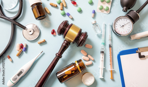 Health and Law flat lay. Judge gavel, medical stethoscope and medicine