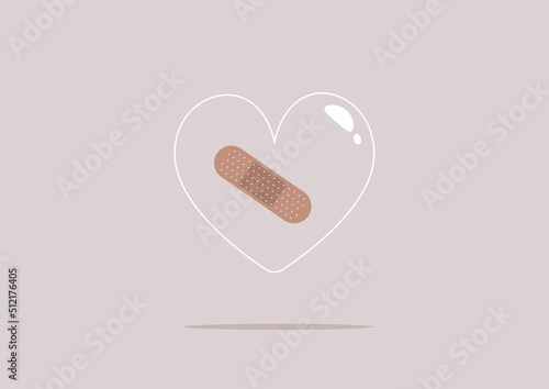 A bandaid sticked to a transparent glass heart, a heartbreak concept