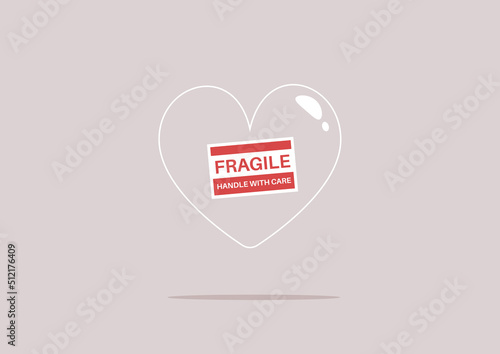 A transparent heart with a fragile sticker on it, a heartbreak concept