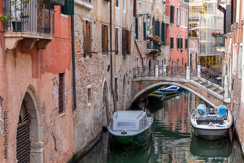 Narrow canal in the city of Venice on a summer day