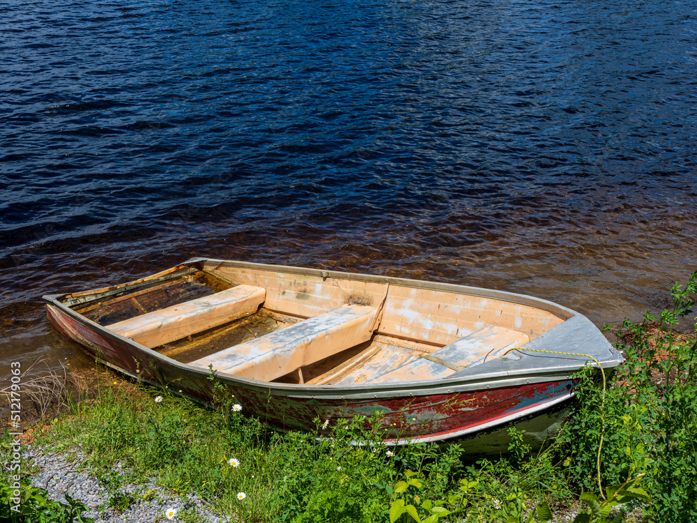 old boat on shore of lake
