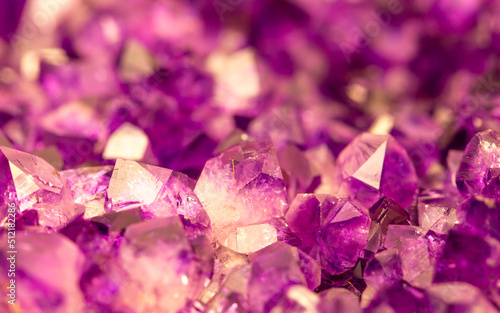 Amethyst pink crystals. Gems. Mineral crystals in the natural environment. Texture of precious and semiprecious stones. Seamless background with copy space colored shiny surface of precious stones. photo