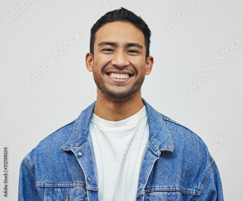 Its a good day to smile. Cropped portrait of a handsome young man posing in studio against a grey background. photo