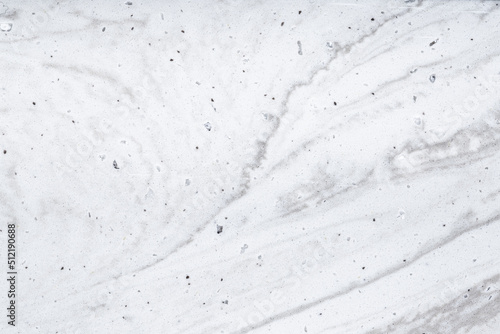 Background Stone wall, white background with abstract gray stains of epoxy. Beautiful marble and granite texture, onyx surface. Finishing stone for the interior. Acrylic stains.