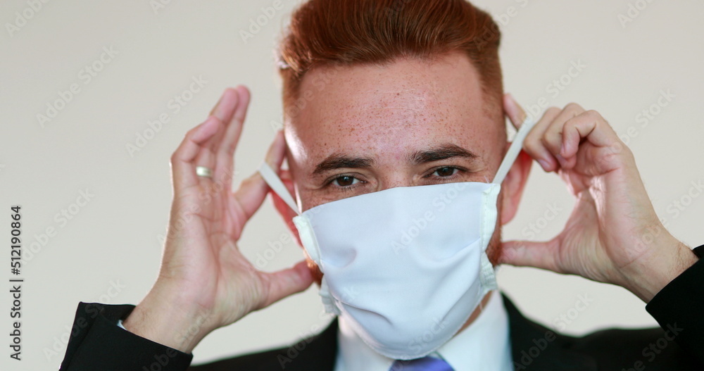 Person removing face mask after pandemic, man feeling relief Person removing face mask after pandemic, man feeling relief