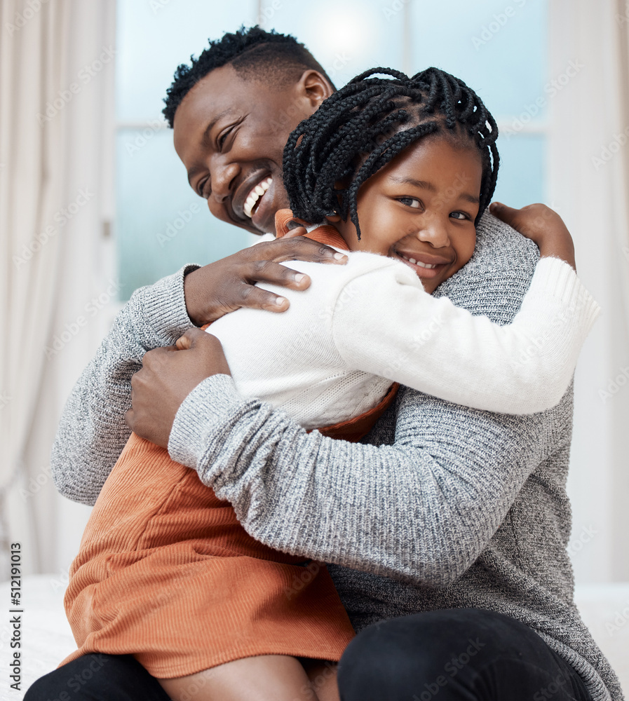 Obraz premium I love you Dad. Shot of a young father hugging his daughter while bonding at home.