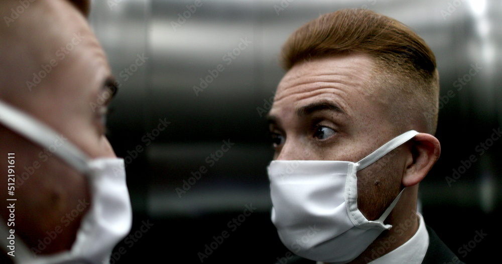 Man touching face with hand wearing surgical mask, person rubbing face with finger Man touching face with hand wearing surgical mask, person rubbing face with finger