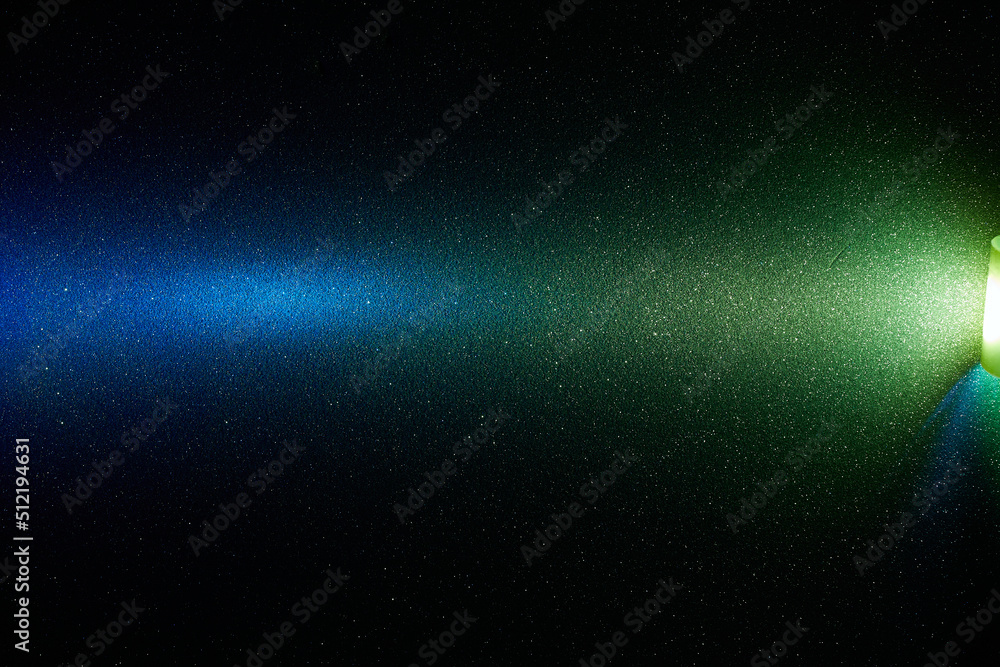 Obraz premium Yellow and blue transient bright gradient beam of light on black background