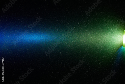 Yellow and blue transient bright gradient beam of light on black background