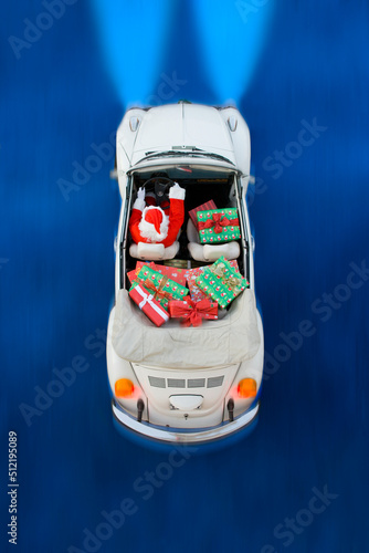 Santa Claus In Car With Christmas Presents photo