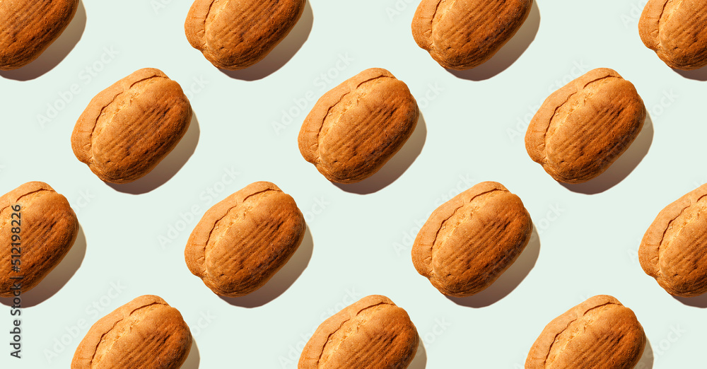 Pattern from bread on blue pastel soft color background. Sourdough bread. Eco-friendly products. Still life. Food concept. Banner Pattern from bread on blue pastel soft color background. Sourdough bread. Eco-friendly products. Still life. Food concept. Banner