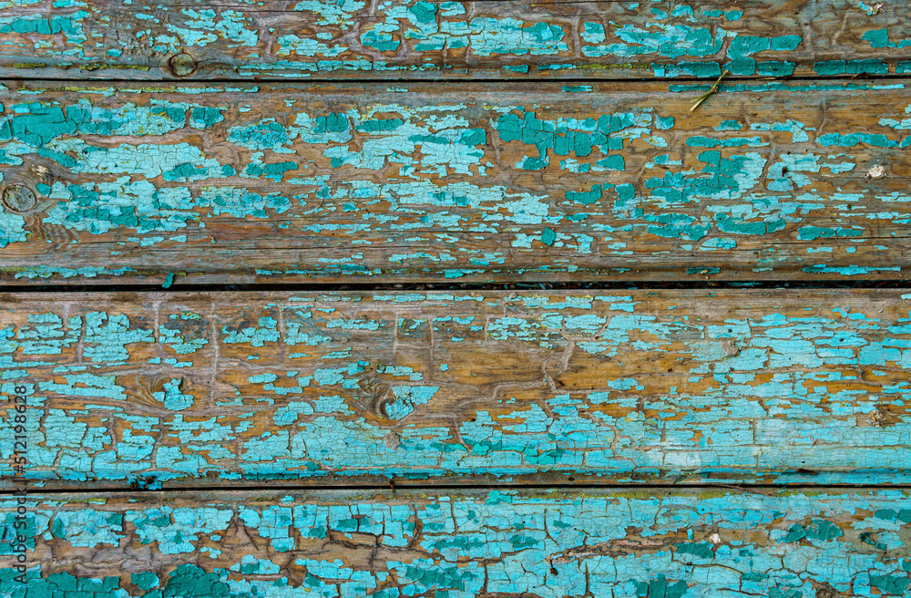 old boards as an abstract wooden background, painted with green paint that peels off