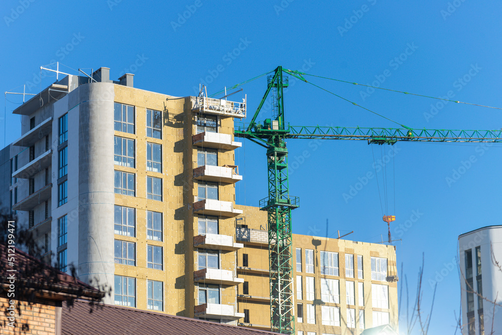 Installation of external wall thermal insulation with rock wool. Exterior passive house wall heat insulation with mineral wool. Insulation facade of multistory residential building. Energy efficiency Installation of external wall thermal insulation with rock wool. Exterior passive house wall heat insulation with mineral wool. Insulation facade of multistory residential building. Energy efficiency
